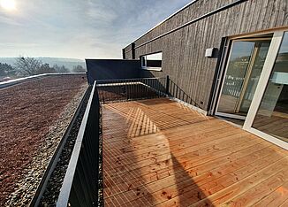 Roof terrace with wooden floorboards in a retirement home in Kümmersbruck.