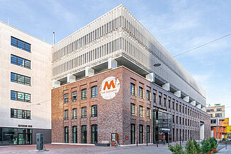 Mixed-use project the Macherei in Munich with different facades.