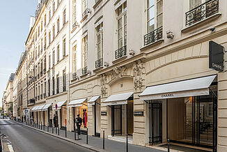 Street view with shop windows and entrance area of the Chanel flagship store in Paris.