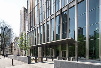 Glass façade with entrance area of the Marienturm mixed-use tower block in Frankfurt.