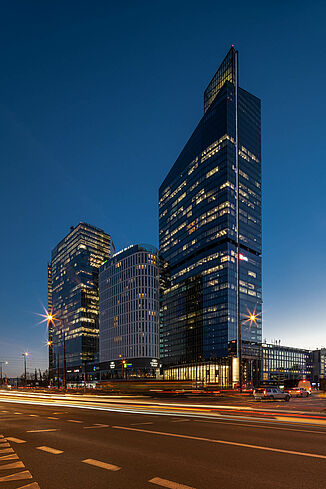 Illuminated Skyliner Tower in Warsaw at night.