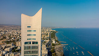 Facade view of the upper floors of the luxury residential tower ONE directly on the beach in Limassol.
