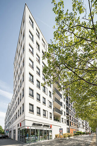 Corner view of the Alea Quartier in Frankfurt with pharmacy and flats above.