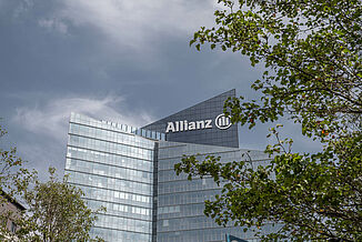 The Allianz One Tower in Paris with trees in front of it.
