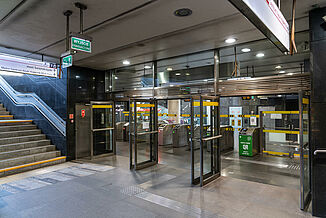 Grey tiled entrance area with access control in a metro in Warsaw.