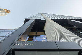 Detailed facade view of the Warsaw Skyliner Tower with Skyliner lettering.
