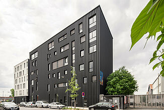 Street view of the façade of the Pôle PIXEL office and commercial building in France.