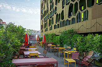 Terrace of the MOB Hotel in Lyon with seating and greenery.