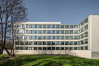 Modern office complex with glass front in Warsaw's Powiślethia district.