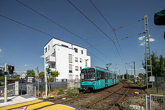 Street view of an apartment block in Oberursel with passing tram.