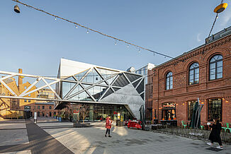 The Koneser mixed-use project in Warsaw is a mix of old brick buildings and modern architecture made of glass and steel.